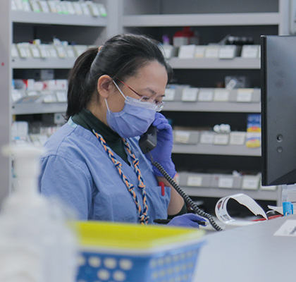 Pharmacist working at a pharmacy counter.