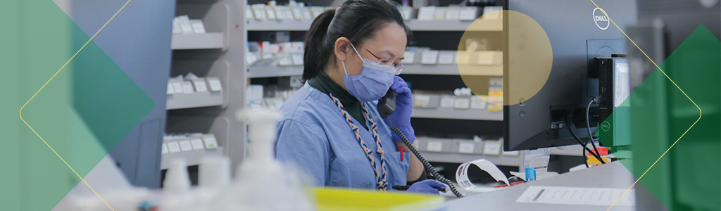 Pharmacist working at a pharmacy counter.