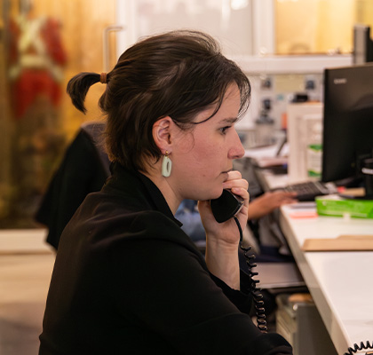 Person speaking on a telephone in an office.